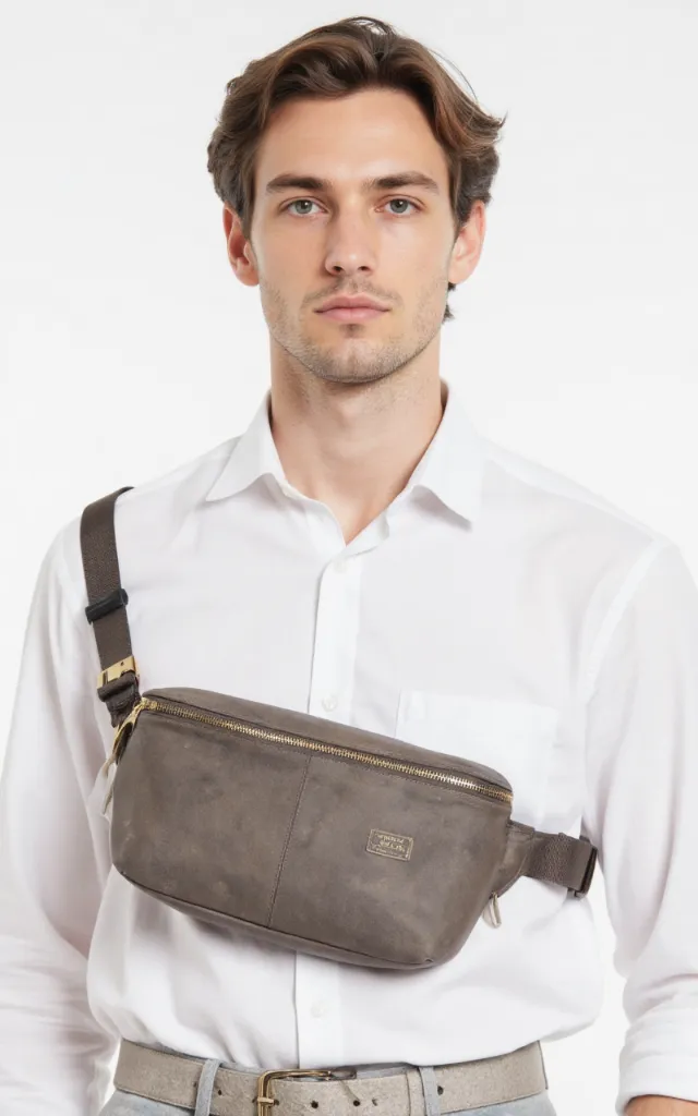 A French male model with a Waist bag with belt, wearing a shirt, against a white background, in a front   facing close   up